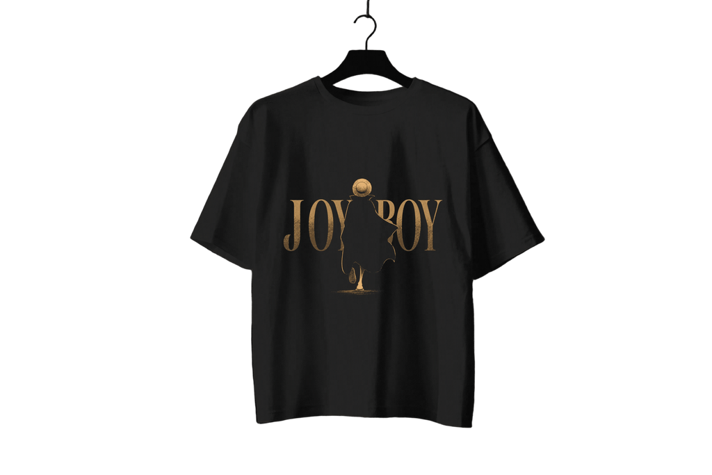 A black short-sleeve t-shirt hanging on a black hanger against a dark background, featuring a gold graphic print on the front with the text 'JOY BOY' and a stylized figure.